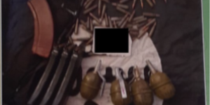 An image of ammunition, and grenades on top of an ISIS flag.  